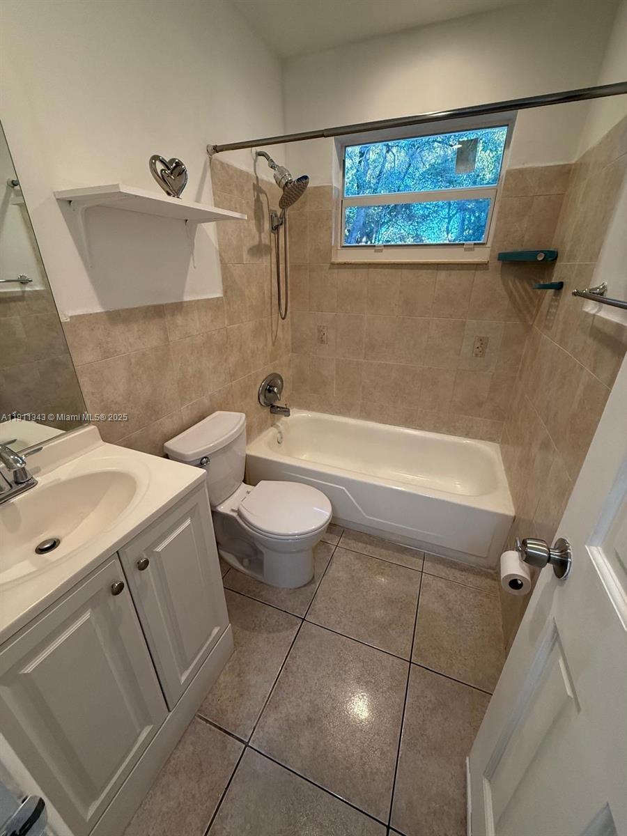 620 Southwest 7th Avenue, Unit 2 Hallandale Beach, FL 33009 - Photo 17 of 23 a bathroom with a sink toilet and shower