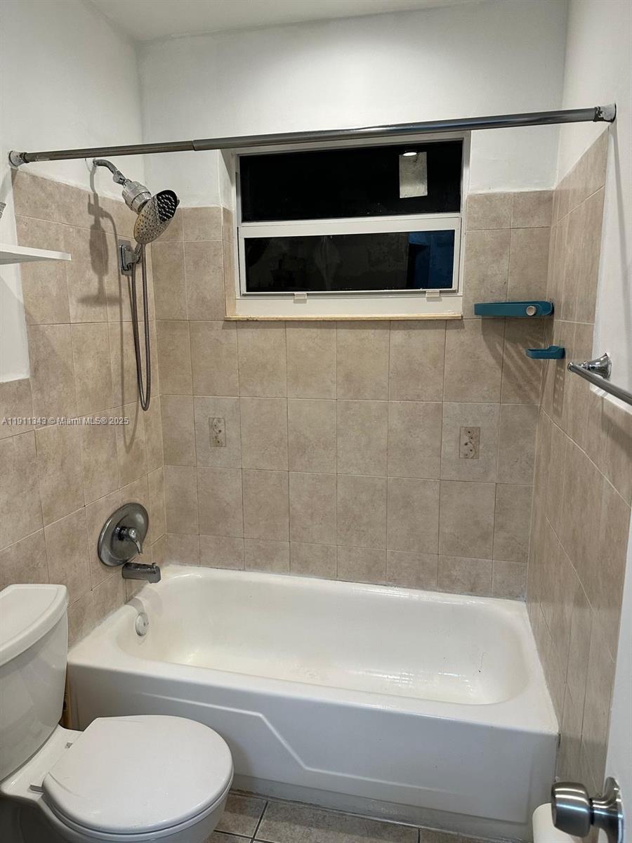 620 Southwest 7th Avenue, Unit 2 Hallandale Beach, FL 33009 - Photo 2 of 23 a bathroom with a toilet a sink and a bathtub
