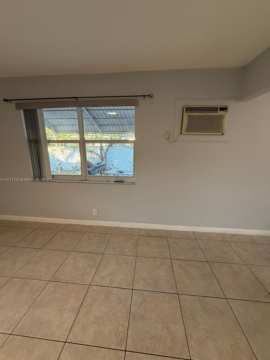 620 Southwest 7th Avenue, Unit 2 Hallandale Beach, FL 33009 - Photo 22 of 23 a view of an empty room with a window