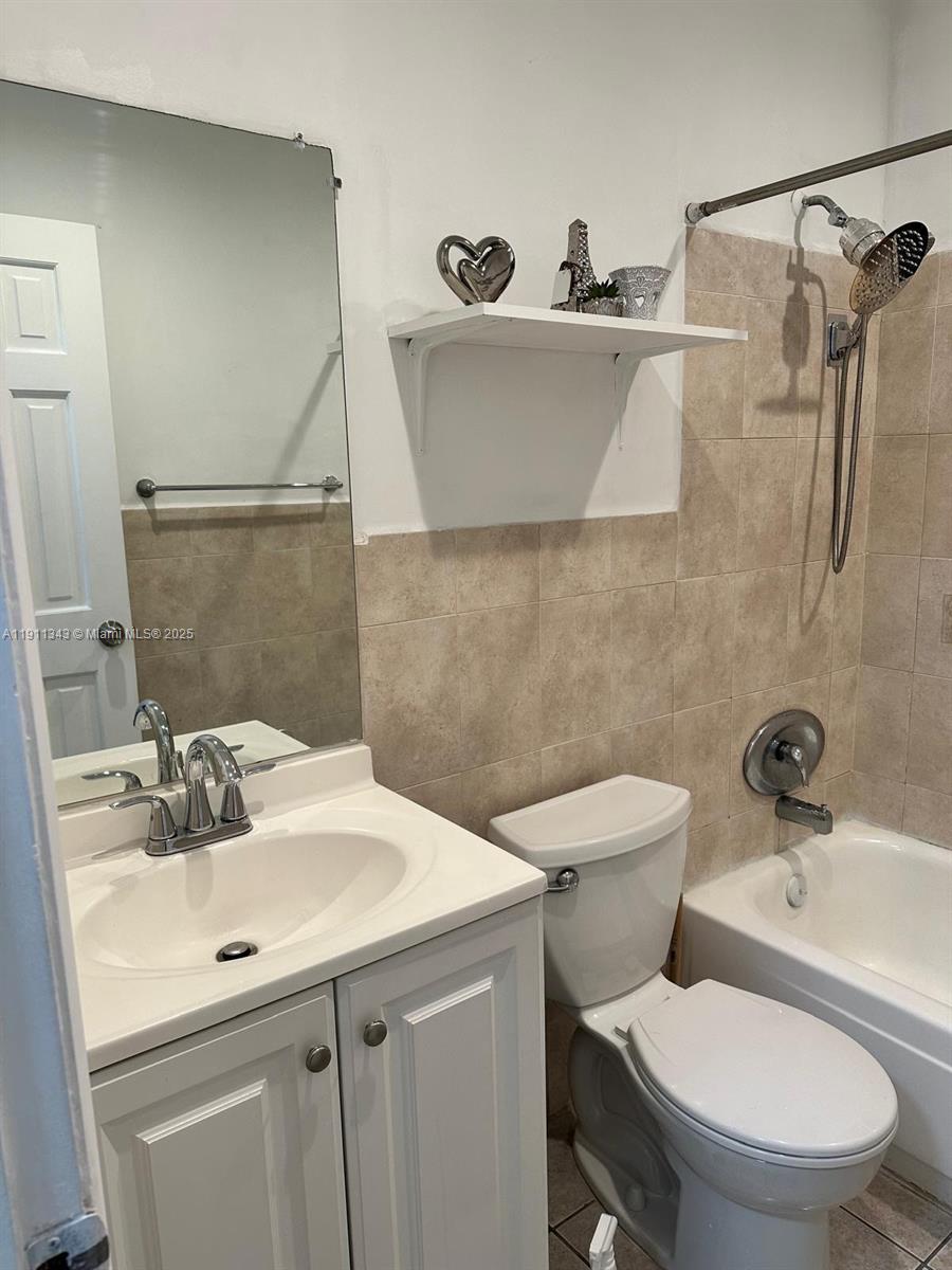 620 Southwest 7th Avenue, Unit 2 Hallandale Beach, FL 33009 - Photo 3 of 23 a bathroom with a sink toilet and shower