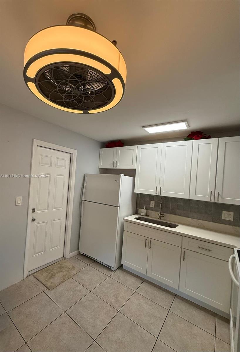 620 Southwest 7th Avenue, Unit 2 Hallandale Beach, FL 33009 - Photo 8 of 23 a kitchen with a sink and cabinets