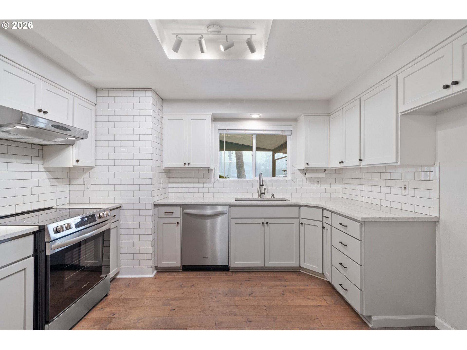 5546 Sinclair Street West Linn, OR 97068 - Photo 13 of 46 a kitchen with granite countertop a stove sink and cabinets