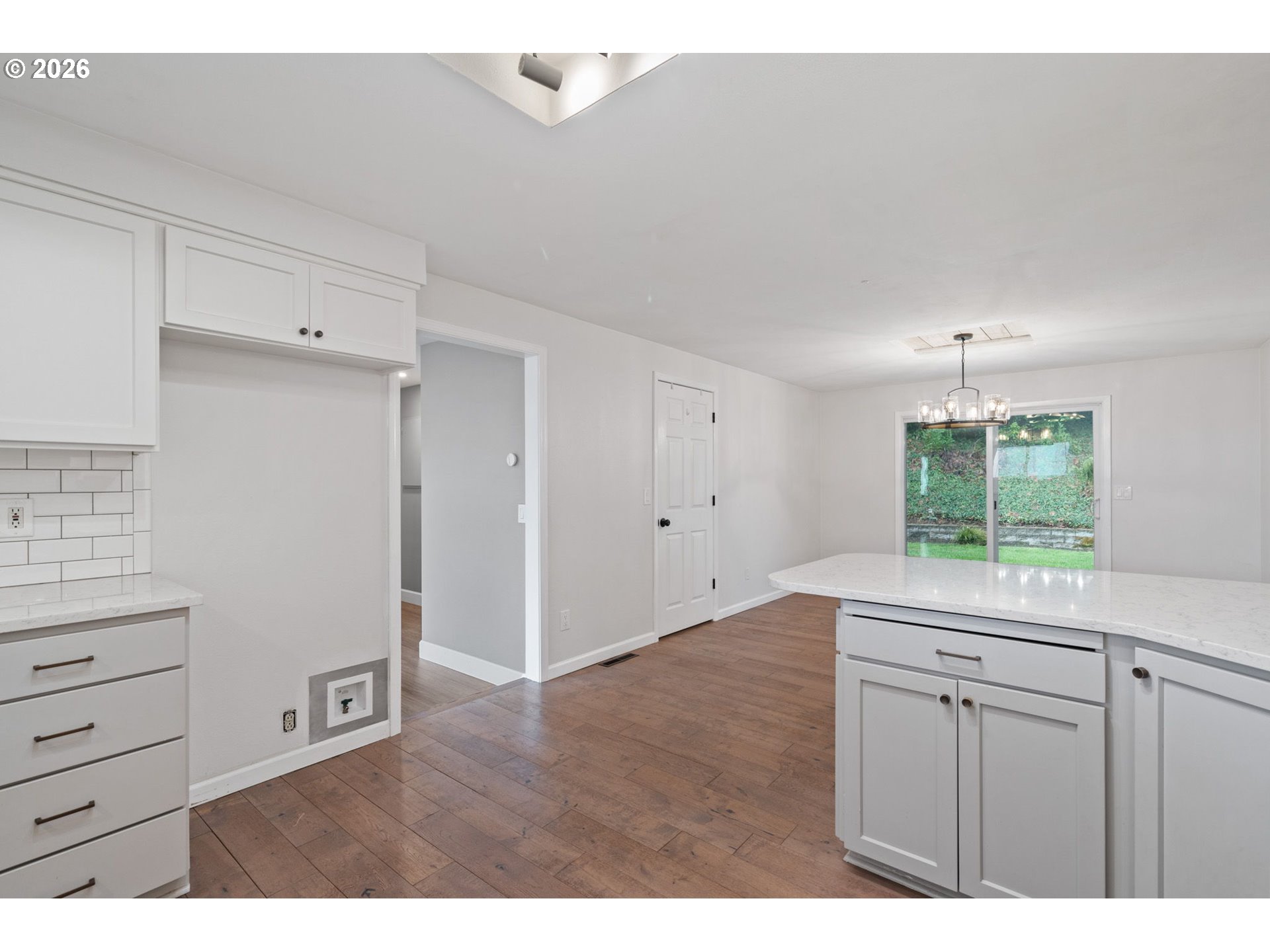 5546 Sinclair Street West Linn, OR 97068 - Photo 17 of 46 a kitchen with a wooden floor and white cabinets