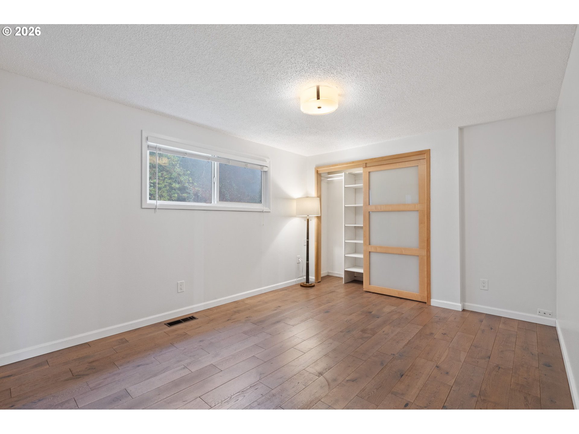 5546 Sinclair Street West Linn, OR 97068 - Photo 24 of 46 a view of an empty room with wooden floor and a window
