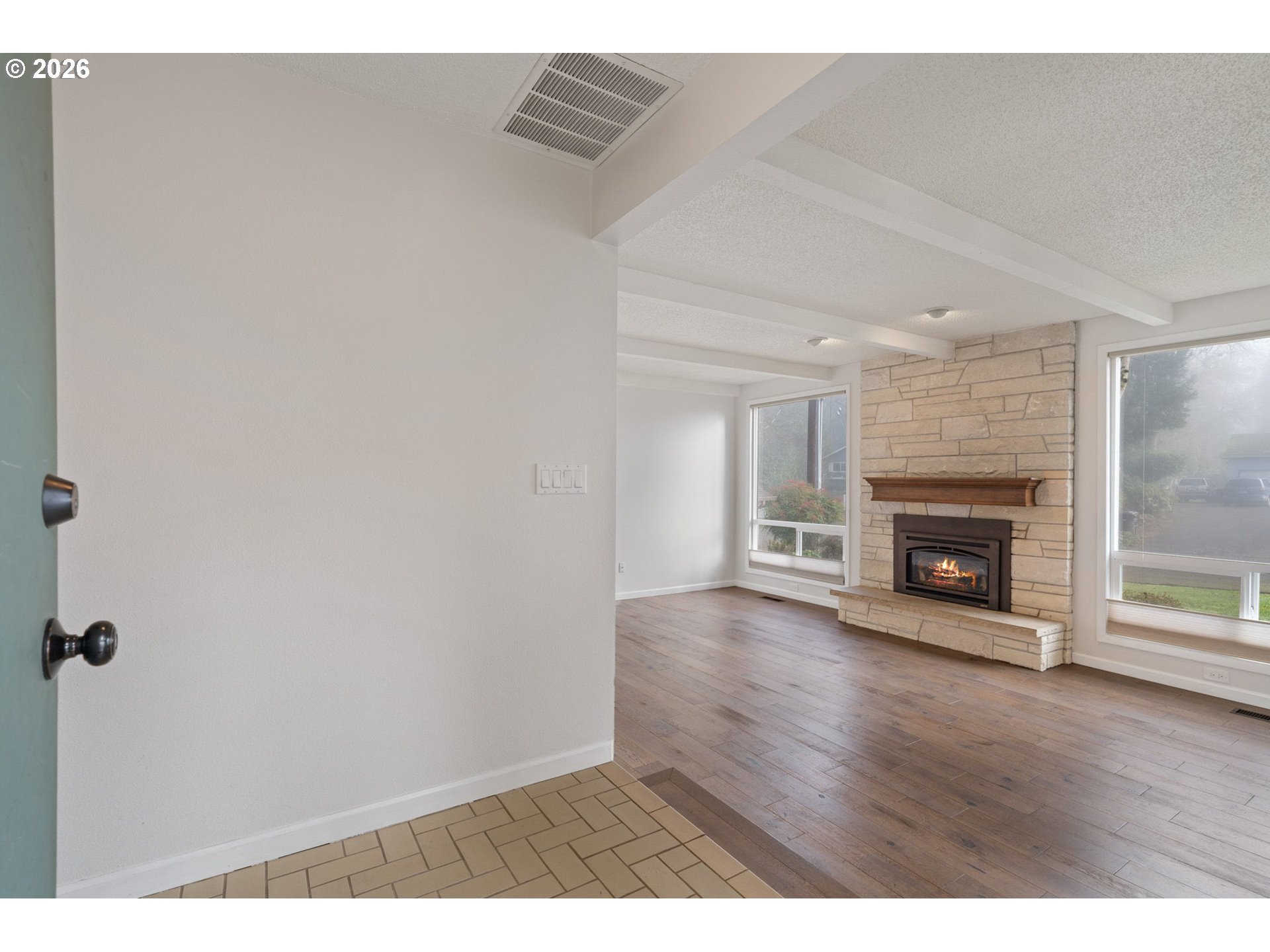 5546 Sinclair Street West Linn, OR 97068 - Photo 5 of 46 a view of an empty room with wooden floor fireplace and a window