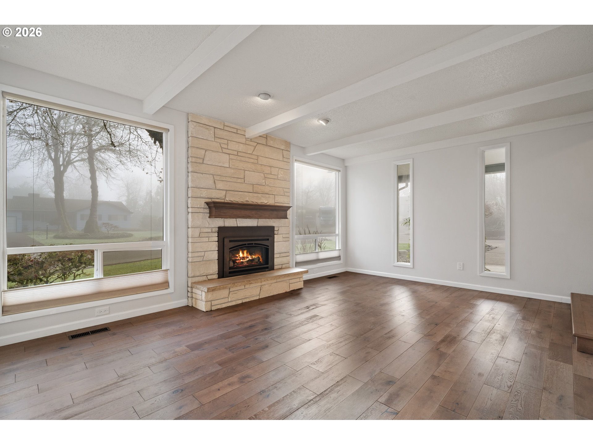5546 Sinclair Street West Linn, OR 97068 - Photo 6 of 46 a view of empty room with wooden floor and fireplace