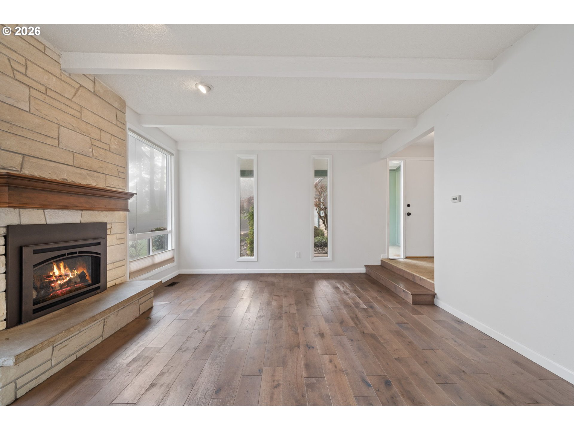 5546 Sinclair Street West Linn, OR 97068 - Photo 7 of 46 a view of an empty room with wooden floor fireplace and a window