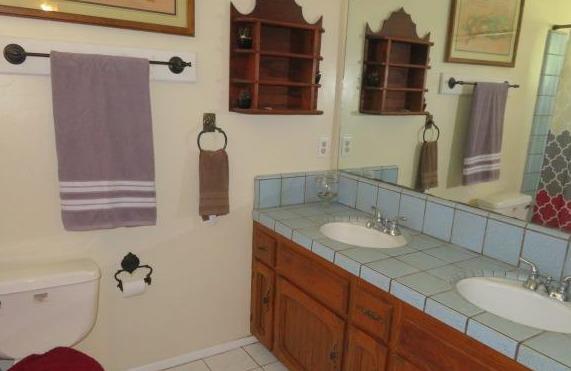 26681 Club Drive Madera, CA 93638 - Photo 19 of 41 a bathroom with a granite countertop sink and a mirror