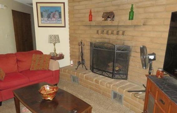 26681 Club Drive Madera, CA 93638 - Photo 8 of 41 a living room with furniture a flat screen tv and a fireplace