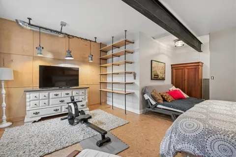 a bedroom with furniture and a flat screen tv
