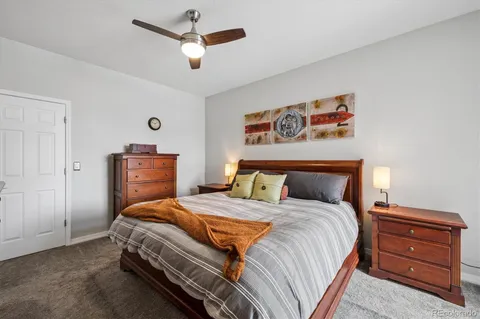 a bedroom with a bed and a dresser in it