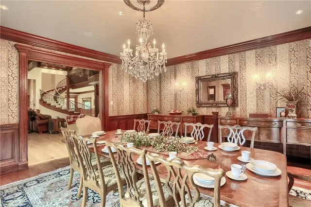 a view of a dining room with furniture and a chandelier