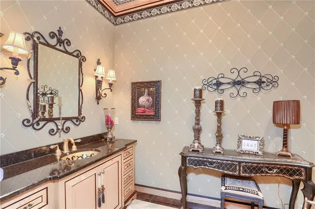 a bathroom with a sink mirror and vanity