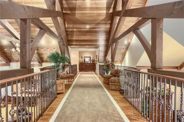 a balcony with chairs and wooden fence