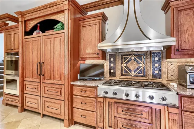 a stove top oven sitting inside of a kitchen