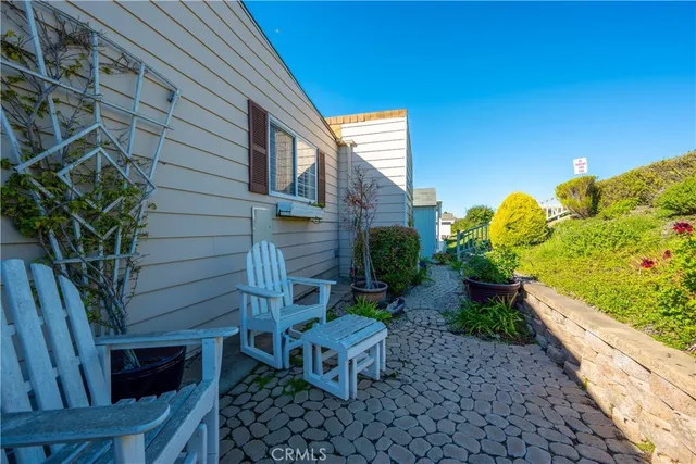 a view of balcony with two chairs and wooden floor