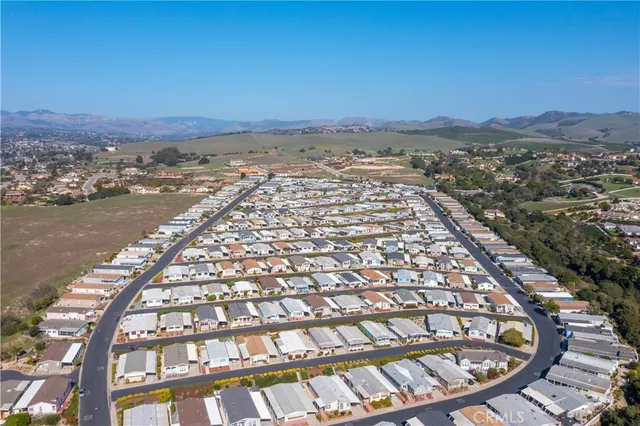 an aerial view of a houses with yard