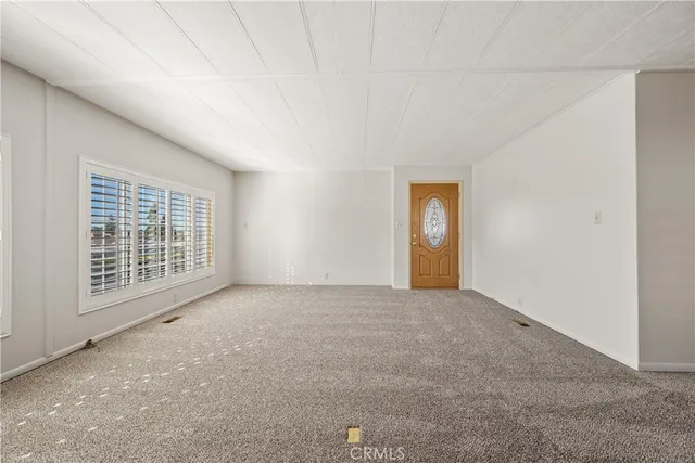 a kitchen with cabinets and wooden floor