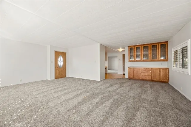 a white kitchen with a sink a refrigerator and cabinets