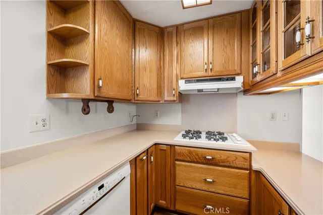 a bathroom with a sink a toilet a mirror and a window