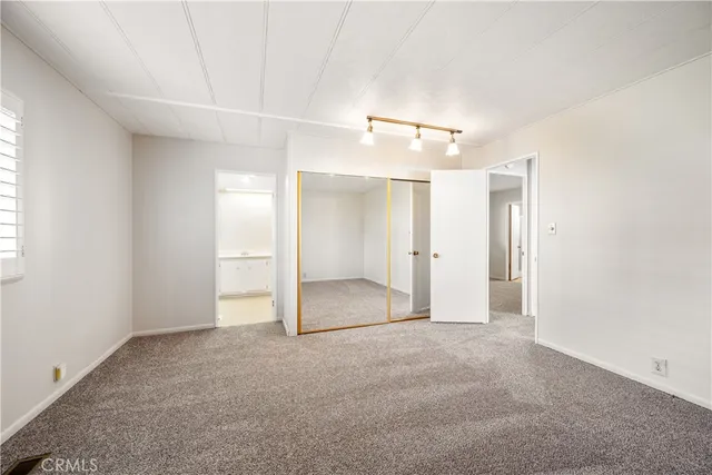 a view of hallway with furniture and windows
