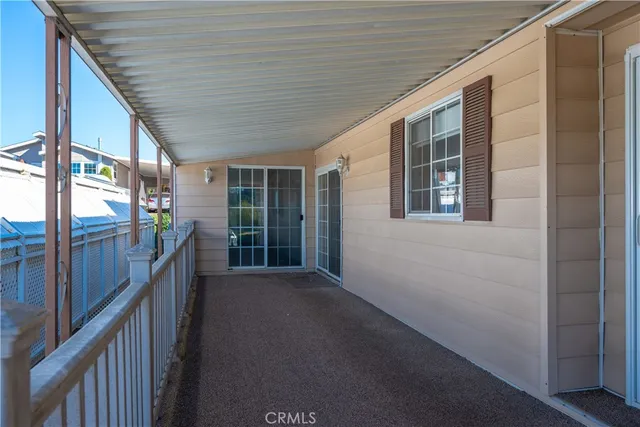 a dining room with furniture potted plants and wooden floor