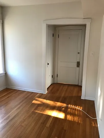 a view of room with wooden floor