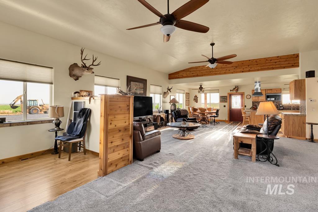 2530 4000 North Filer, ID 83328 - Photo 11 of 48 Carpeted living room with healthy amount of natural light, vaulted ceiling, ceiling fan, and wood finished floors