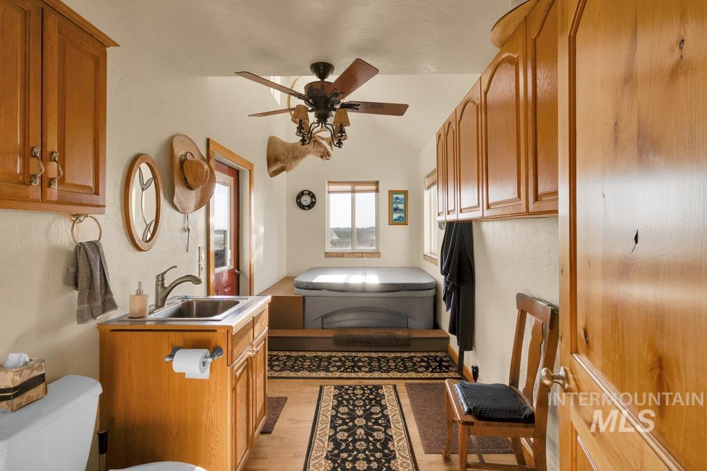 2530 4000 North Filer, ID 83328 - Photo 16 of 48 Bathroom featuring light wood-type flooring, vanity, vaulted ceiling, and a ceiling fan