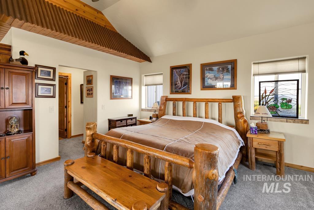 2530 4000 North Filer, ID 83328 - Photo 18 of 48 Bedroom with light carpet, lofted ceiling, and ceiling fan