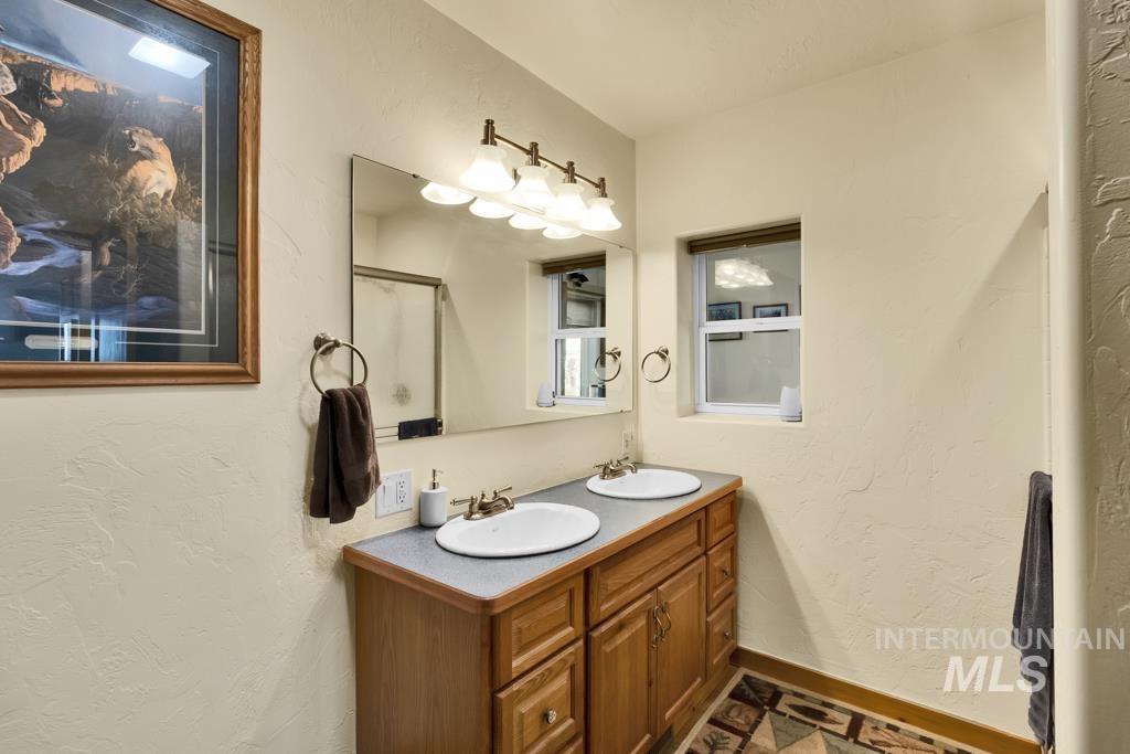 2530 4000 North Filer, ID 83328 - Photo 19 of 48 Full bathroom with a textured wall and double vanity