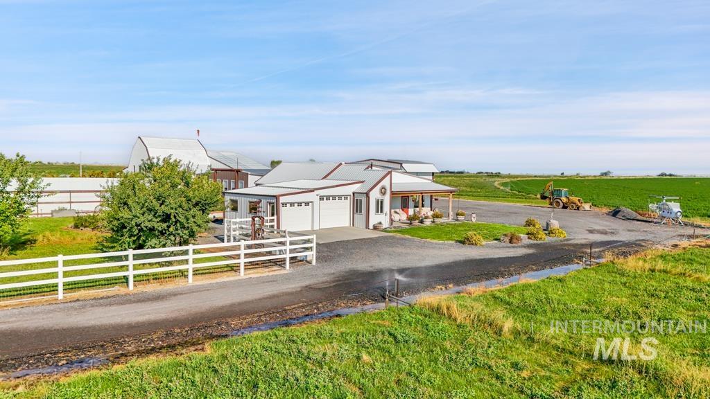 2530 4000 North Filer, ID 83328 - Photo 2 of 48 View of front of house with driveway, a garage, a rural view, and a fenced front yard