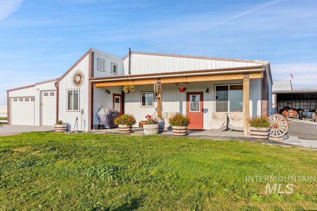 2530 4000 North Filer, ID 83328 - Photo 6 of 48 View of front of property featuring covered porch, a front yard, a garage, and driveway