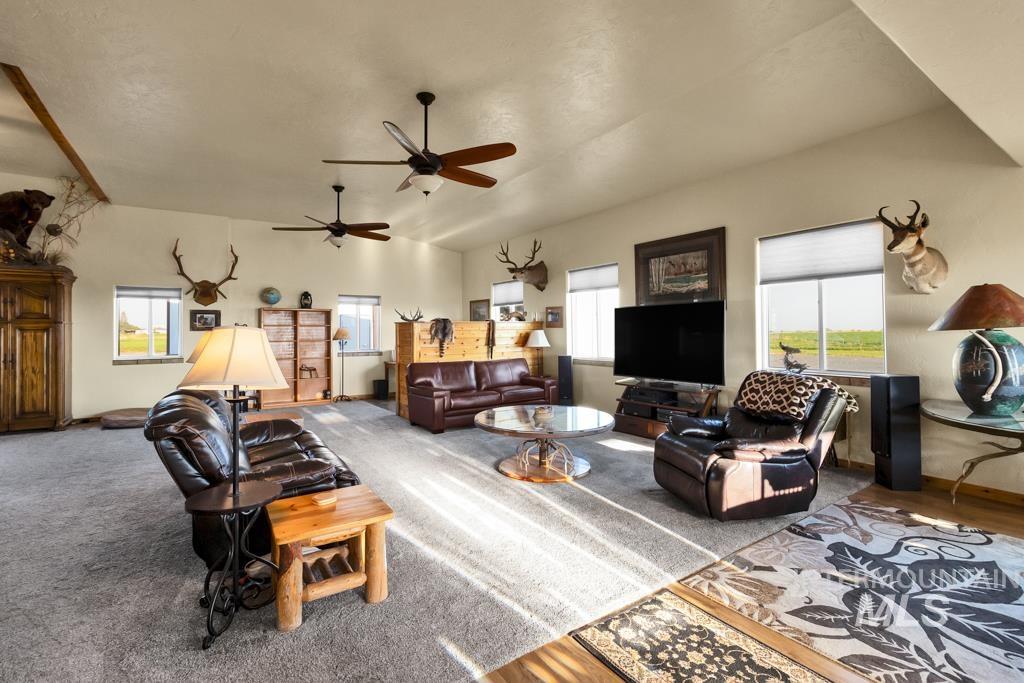 2530 4000 North Filer, ID 83328 - Photo 8 of 48 Carpeted living room with vaulted ceiling and baseboards