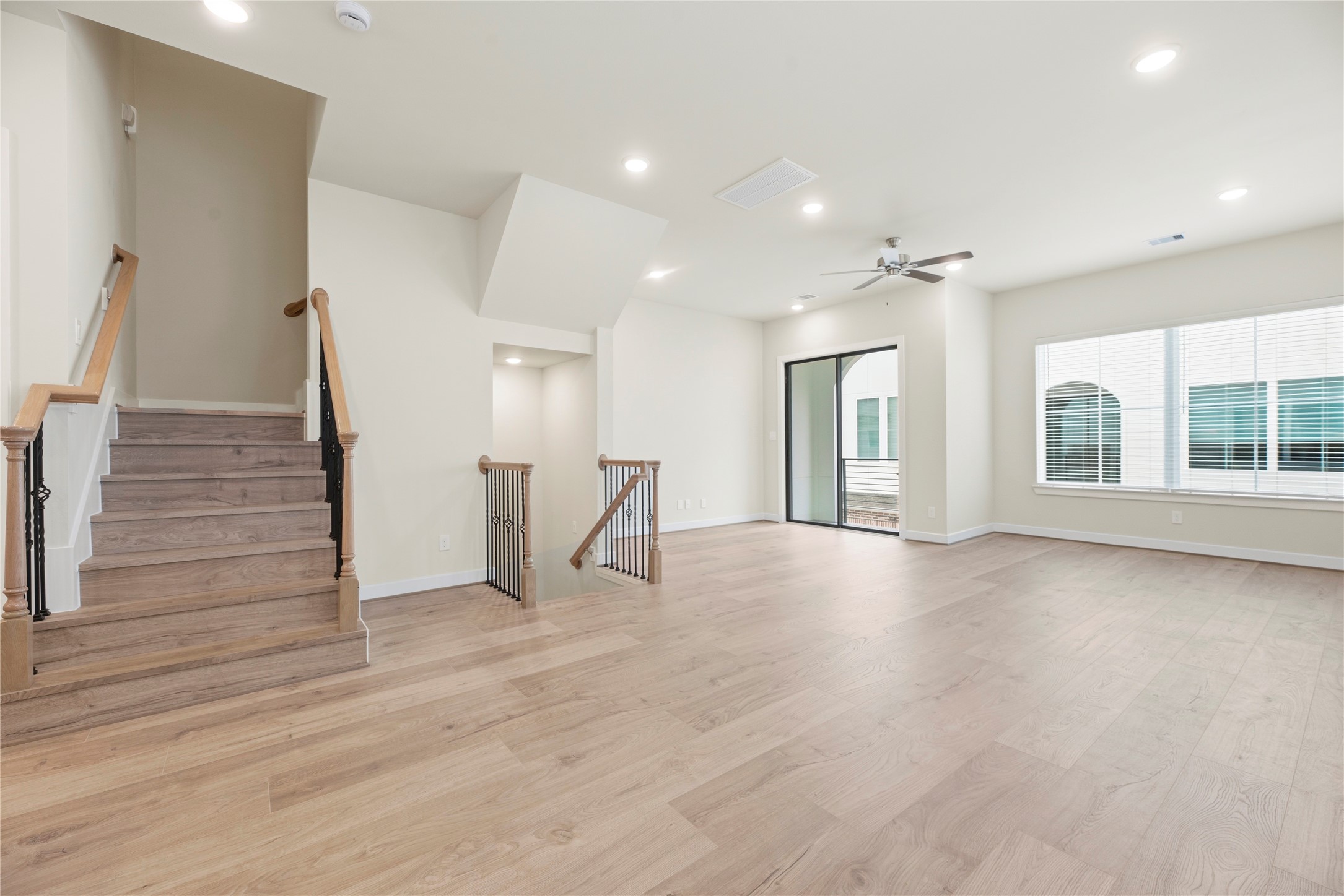 3075 Hicks Street Houston, TX 77007 - Photo 12 of 34 a view of an empty room with wooden floor and windows