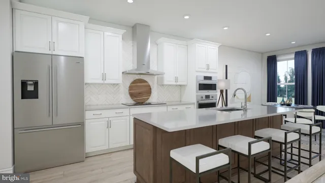 a kitchen with stainless steel appliances granite countertop a white refrigerator a sink a stove a dining table and chairs