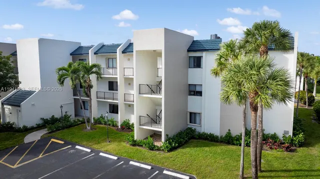 a front view of a house with a garden and plants