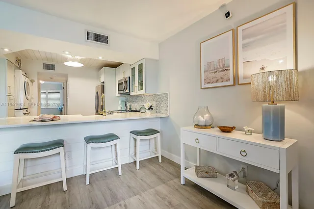 a kitchen with a sink cabinets and wooden floor