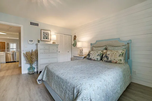 a spacious bedroom with a bed and a view of bathroom