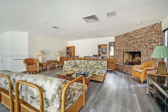 a living room with furniture fireplace and flat screen tv
