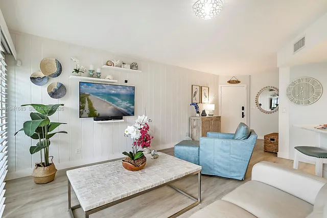 a living room with furniture and flowers