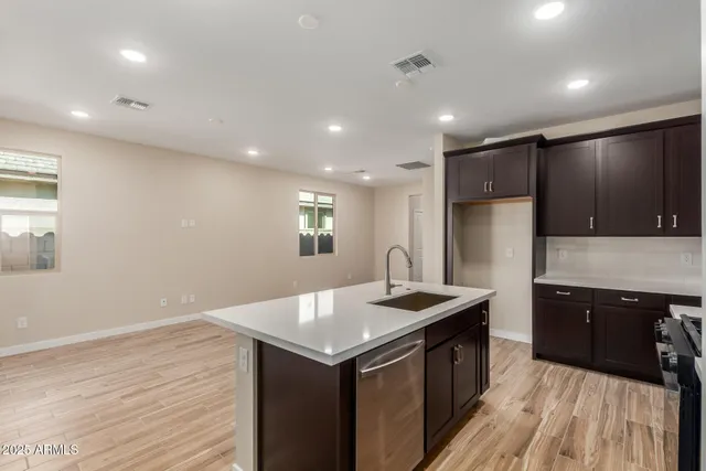 a kitchen with a sink vanity and refrigerator