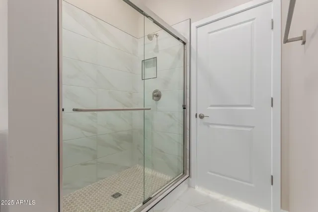 a bathroom with a glass shower door
