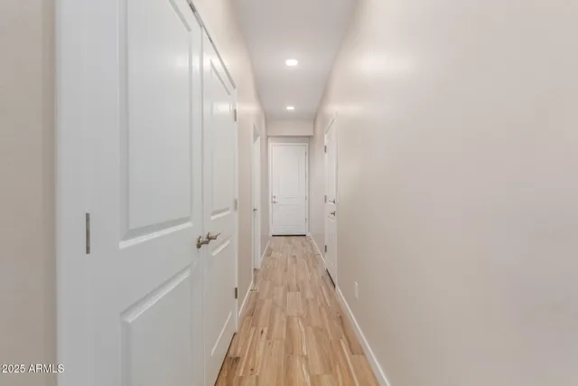 a view of a hallway with wooden floor