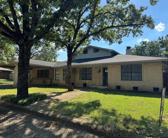 a front view of house with yard and green space