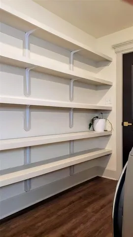 a view of a closet with wooden floor