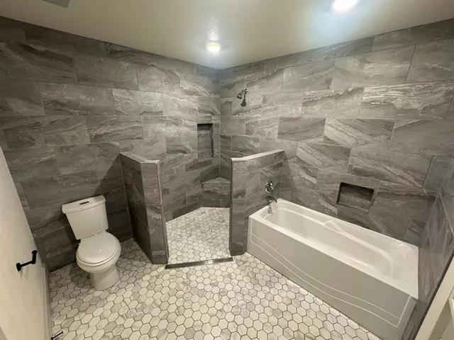 a bathroom with a bathtub and a sink