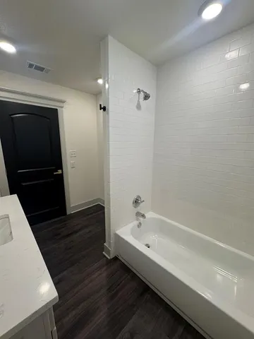 a bathroom with a bathtub and a sink