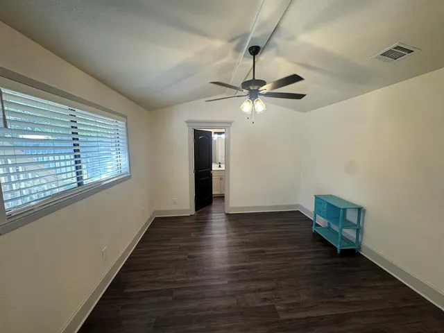 a bathroom with a granite countertop bathtub shower and toilet