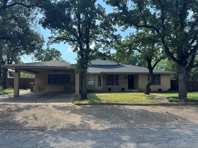 a house that has a tree in front of it